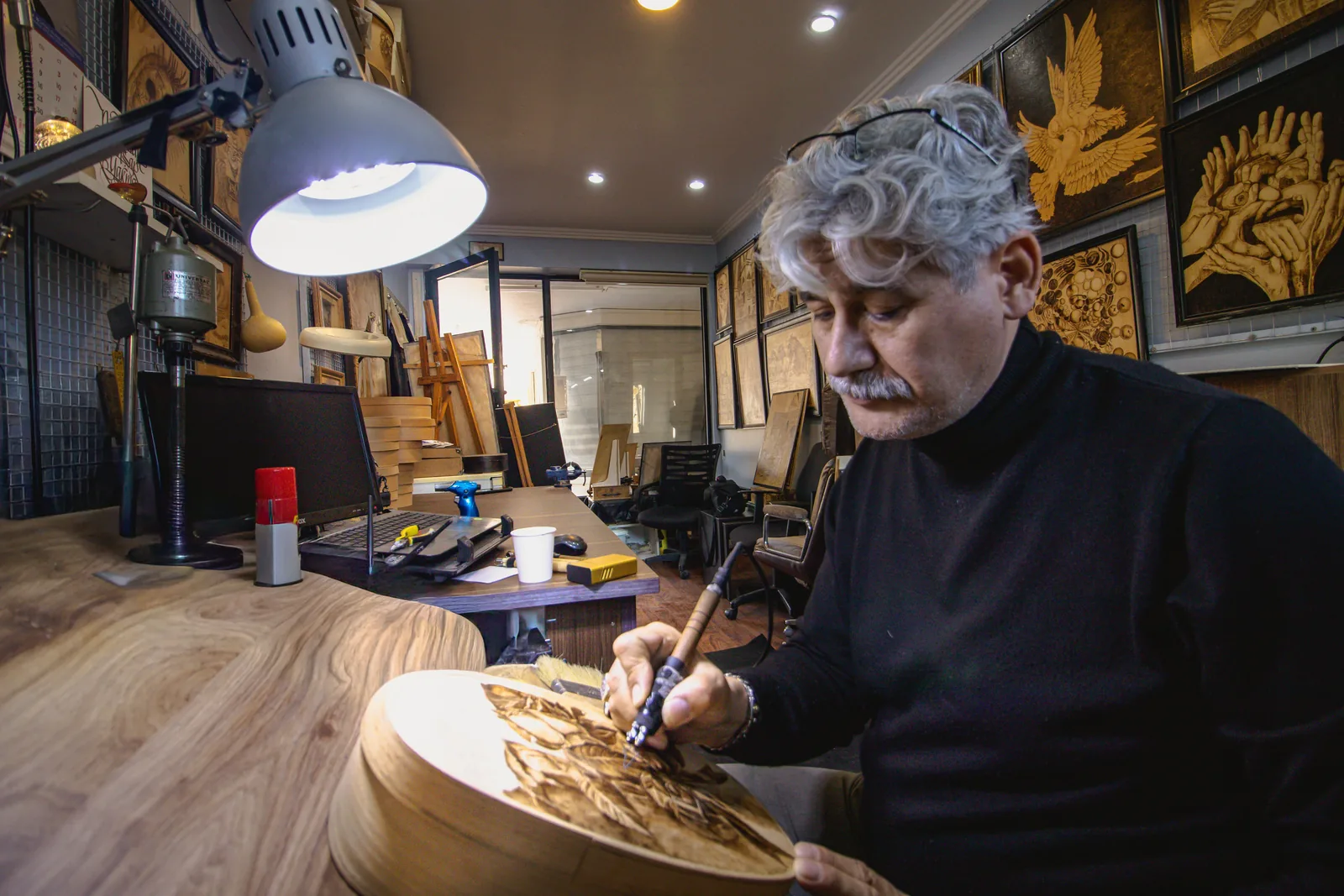 Artisan engraving a customized product in a small workshop